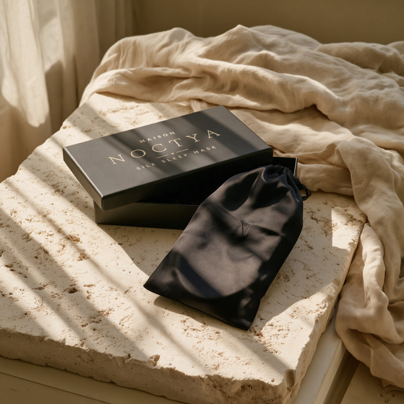 Écrin noir Maison Noctya et pochette en soie, coloris Nuit, sur travertin